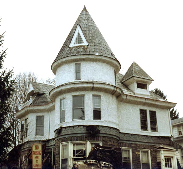 white house with turret on corner, 2 dormers