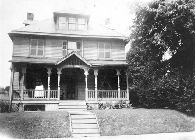 3-story house with elaborate fron porch