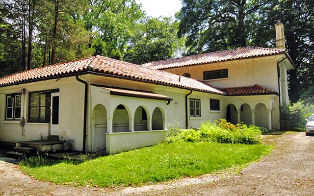 white stucco house with red tile roof