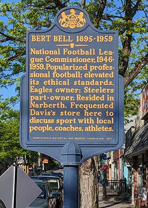 metal state marker; state seal at top, raised yellow letters on blue background