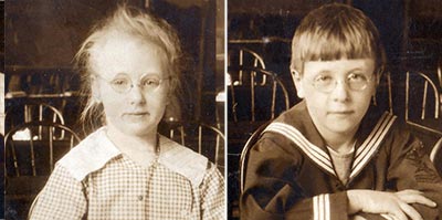 A boy and a girl, with very similar faces and expressions wearing identical glasses