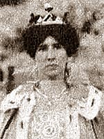 young dark-haired woman wearing crown and fur-trimmed cape