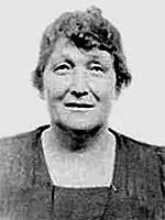 passport portrait of olderf woman in plain black dress