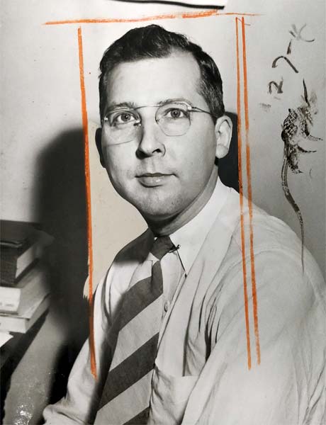 young man wearing round wire-frame glasses and a striped tie