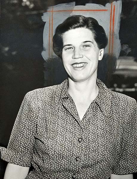 smiling woman wearing patterned dress top