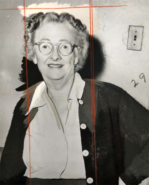 smiling older woman wearing glasses, open sweater