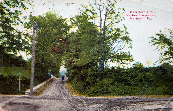 intersection of two unpaved roads with horse & buggy.